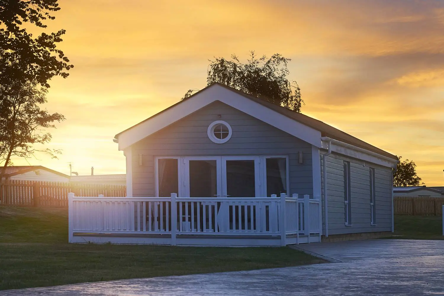 Prefab ADU home with porch during sunset